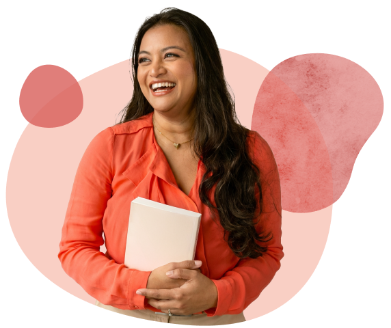 image-peri-menopause Smiling woman with coral blouse holding a notebook
